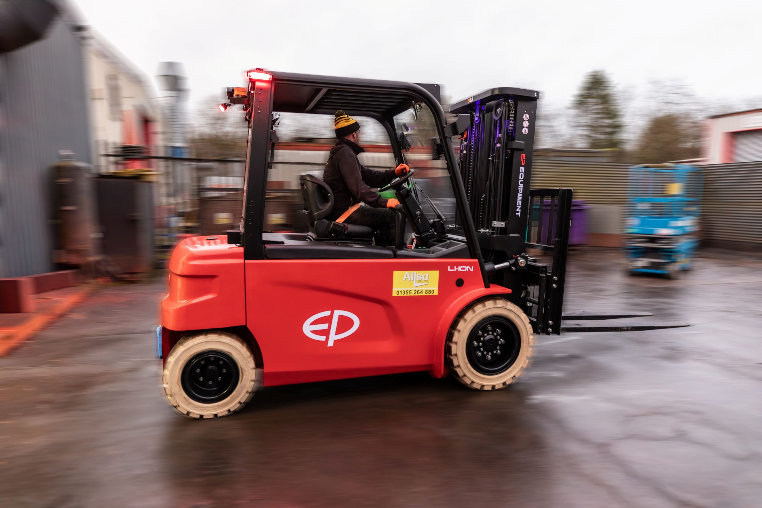 An action shot of an Ailsa employee driving a forklift